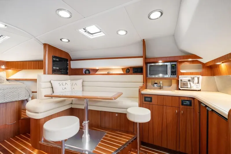  Yacht Photos Pics Luxurious interior of 2004 Tiara Yachts 3800 Open with modern kitchen and cozy seating area.