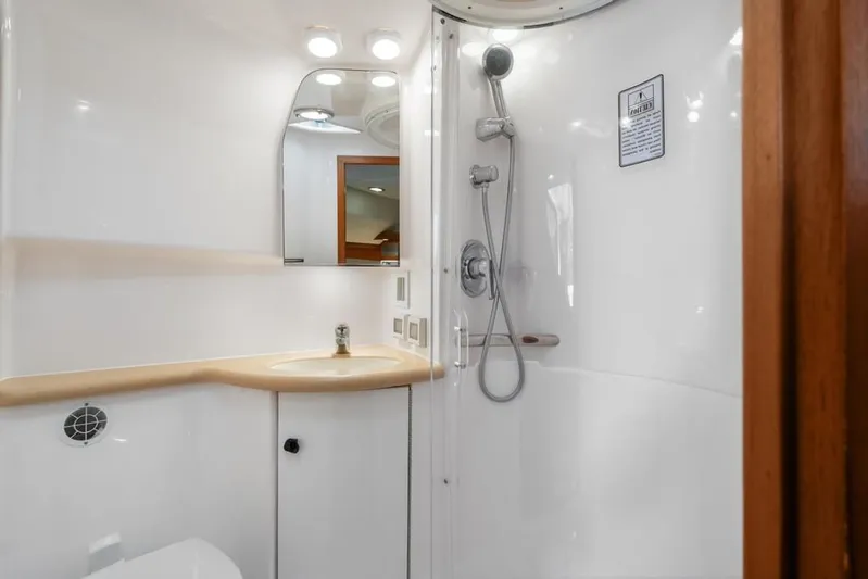  Yacht Photos Pics Luxurious bathroom in 2004 Tiara Yachts 3800 Open, featuring modern shower and sink.