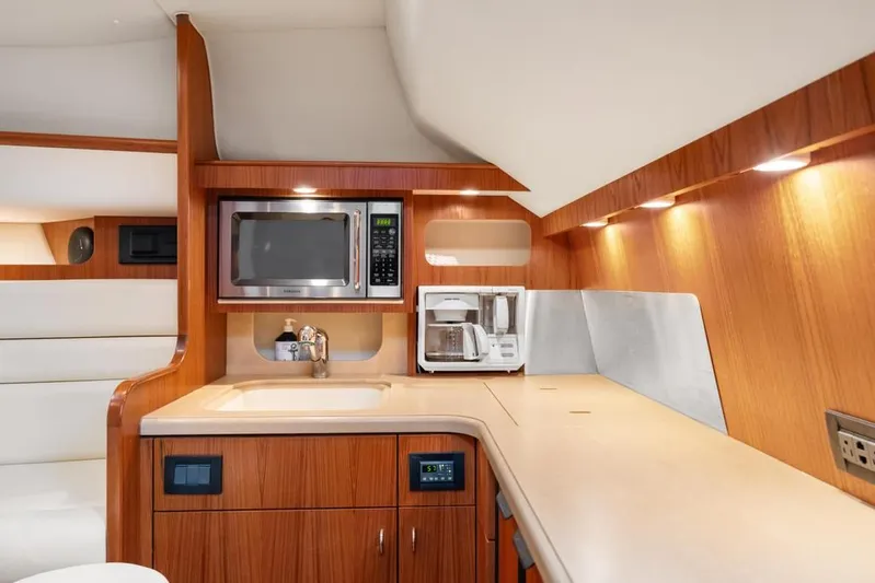  Yacht Photos Pics 2004 Tiara Yachts 3800 Open galley with wood cabinetry, microwave, and coffee maker.