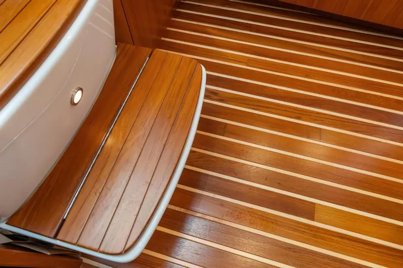  Yacht Photos Pics Luxurious wooden interior of 2004 Tiara Yachts 3800 Open, showcasing elegant flooring and seating.