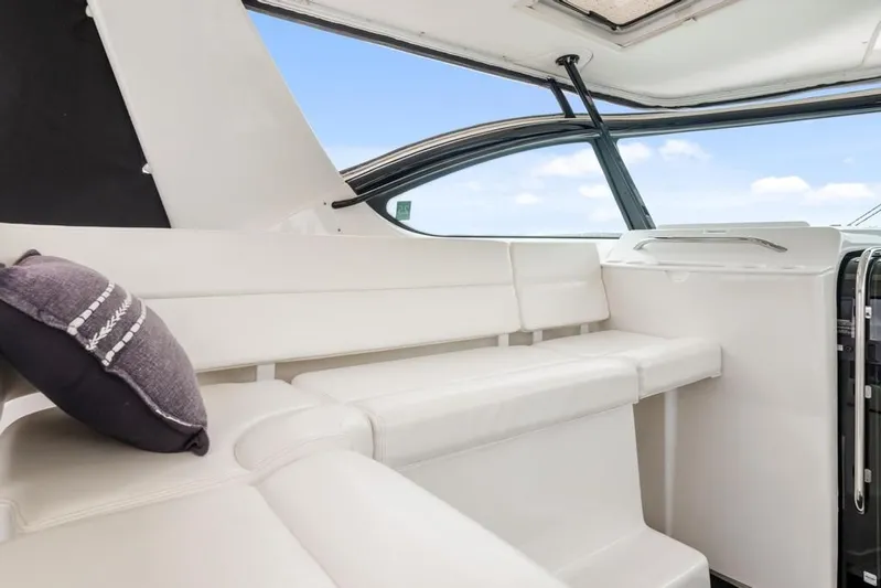 Yacht Photos Pics 2004 Tiara Yachts 3800 Open interior with white seating and decorative pillow.