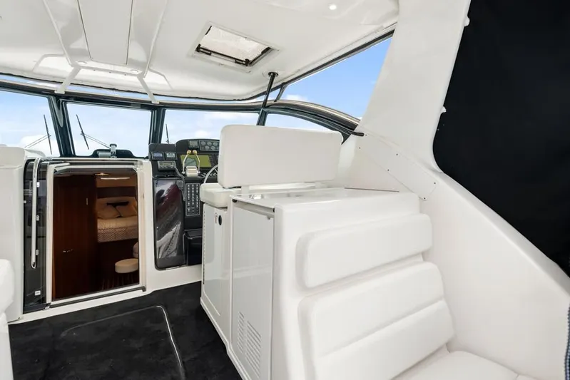  Yacht Photos Pics 2004 Tiara Yachts 3800 Open interior with helm, seating, and cabin entrance.