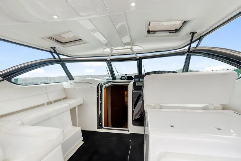  Yacht Photos Pics 2004 Tiara Yachts 3800 Open interior with white seating and modern helm.