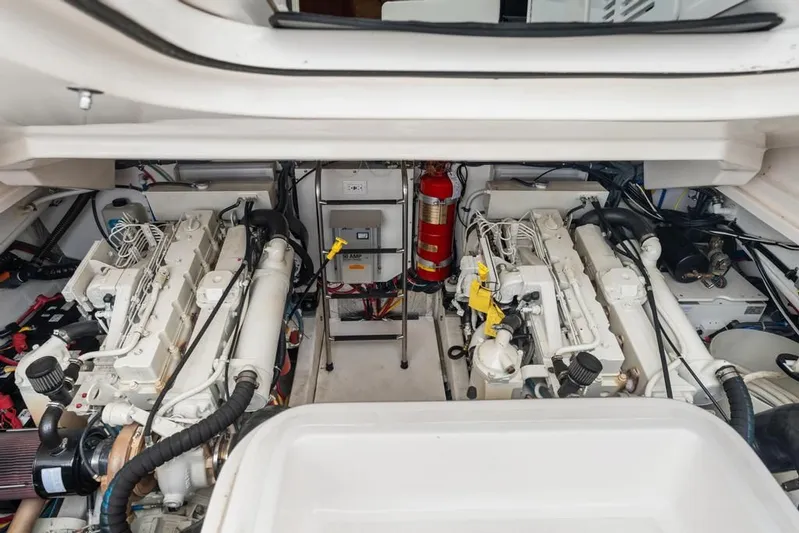  Yacht Photos Pics Engine room of 2004 Tiara Yachts 3800 Open, featuring dual engines and fire extinguisher.