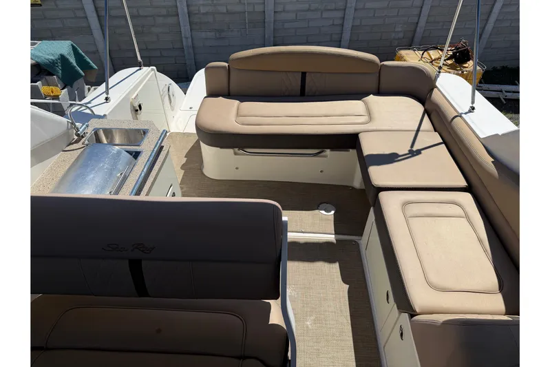  Yacht Photos Pics 2017 Sea Ray Sundancer 310 interior with beige seating and kitchenette.