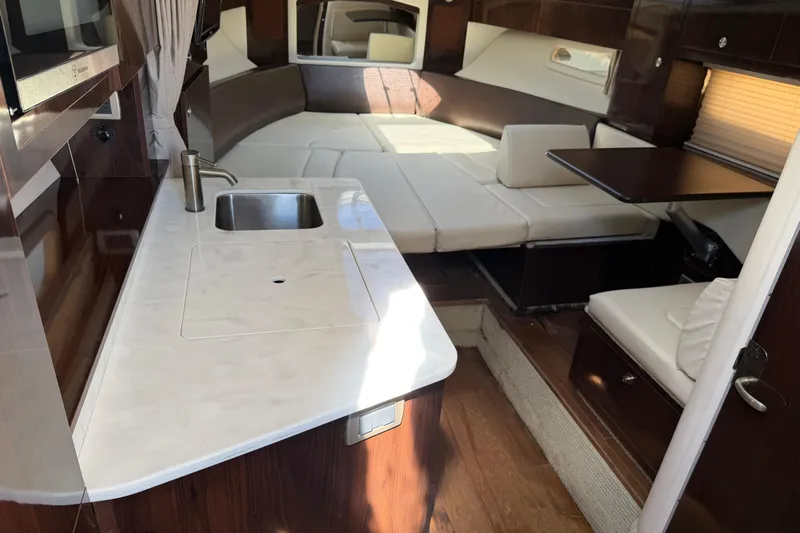  Yacht Photos Pics Interior of 2017 Sea Ray Sundancer 310 yacht with kitchenette and seating area.