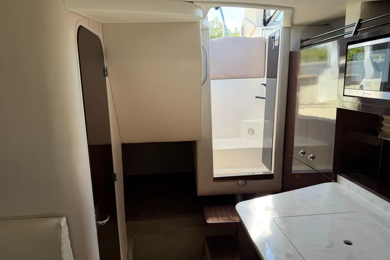  Yacht Photos Pics Interior of 2017 Sea Ray Sundancer 310 yacht, featuring modern kitchenette and cabin access.