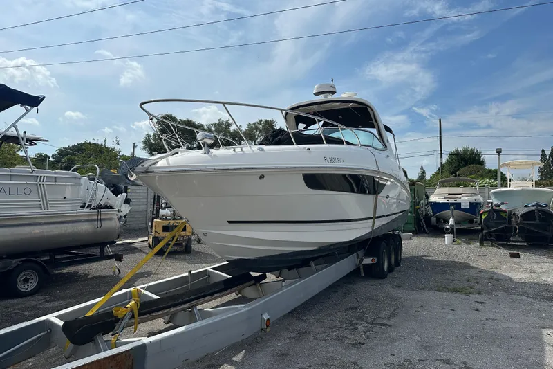  Yacht Photos Pics 2017 Sea Ray Sundancer 310 yacht on trailer in a boatyard under blue sky.