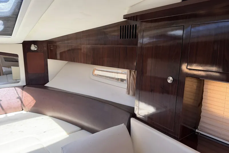  Yacht Photos Pics Interior of 2017 Sea Ray Sundancer 310 with sleek wood cabinetry and seating.