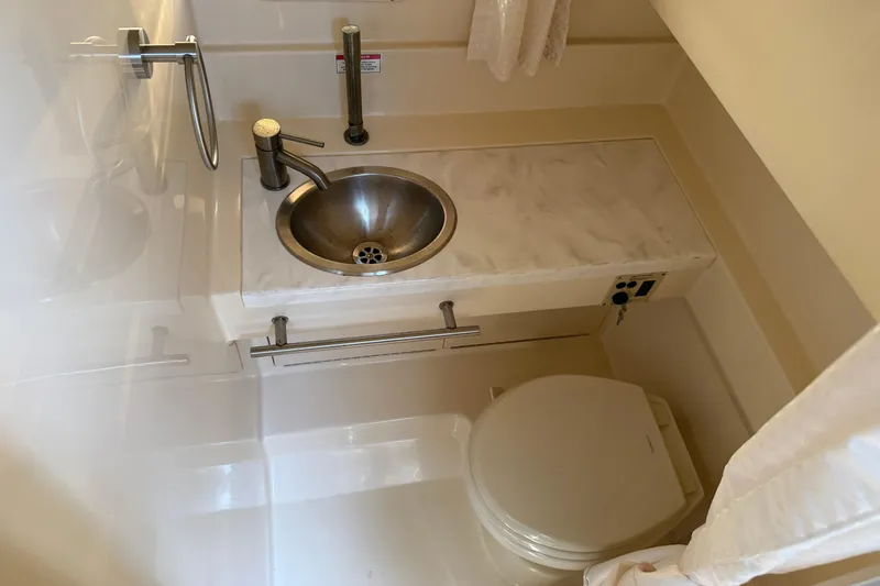  Yacht Photos Pics 2017 Sea Ray Sundancer 310 bathroom with sink and toilet, featuring modern fixtures.