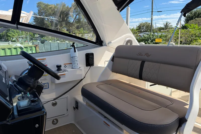  Yacht Photos Pics 2017 Sea Ray Sundancer 310 helm with steering wheel, controls, and cushioned seating.