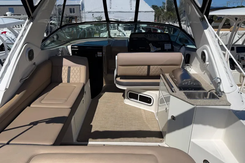 Yacht Photos Pics 2017 Sea Ray Sundancer 310 interior with seating, kitchenette, and helm.