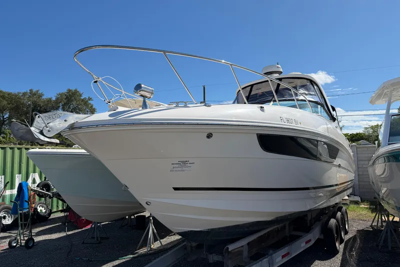  Yacht Photos Pics 2017 Sea Ray Sundancer 310 boat on trailer, parked outdoors under clear blue sky.