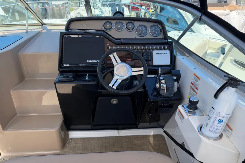  Yacht Photos Pics 2017 Sea Ray Sundancer 310 helm with steering wheel, controls, and navigation equipment.