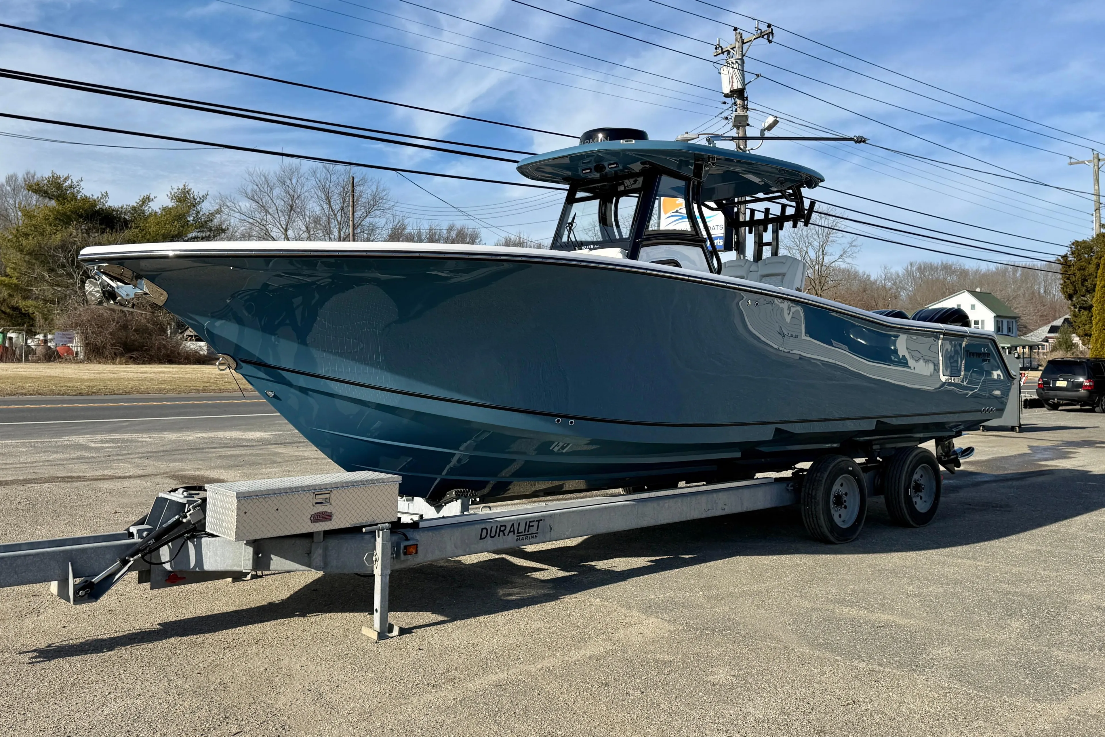 2026 Tidewater 302 CC Adventure boat on trailer, parked outdoors under clear sky.