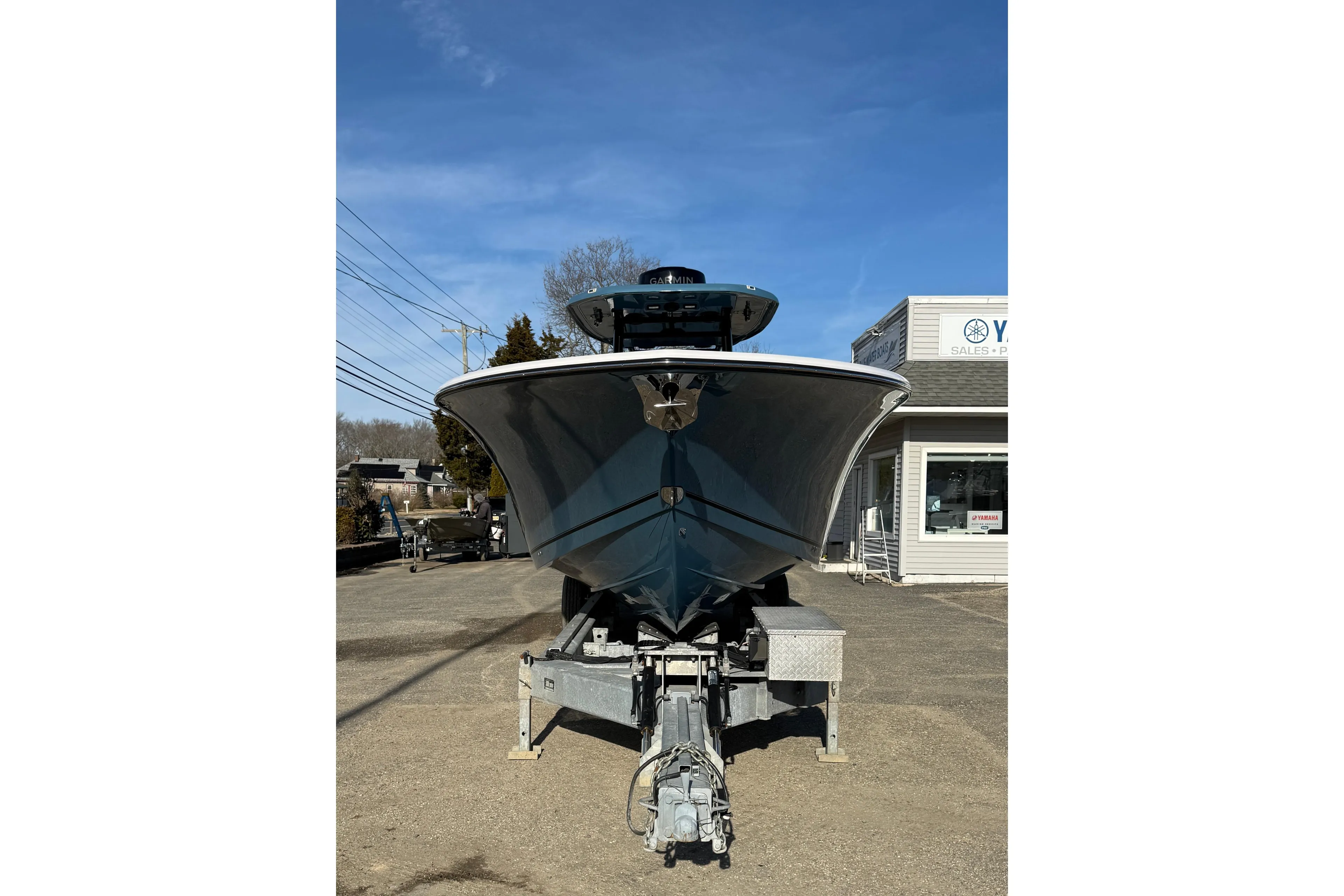 2026 Tidewater 302 CC Adventure boat on trailer, parked outside dealership.
