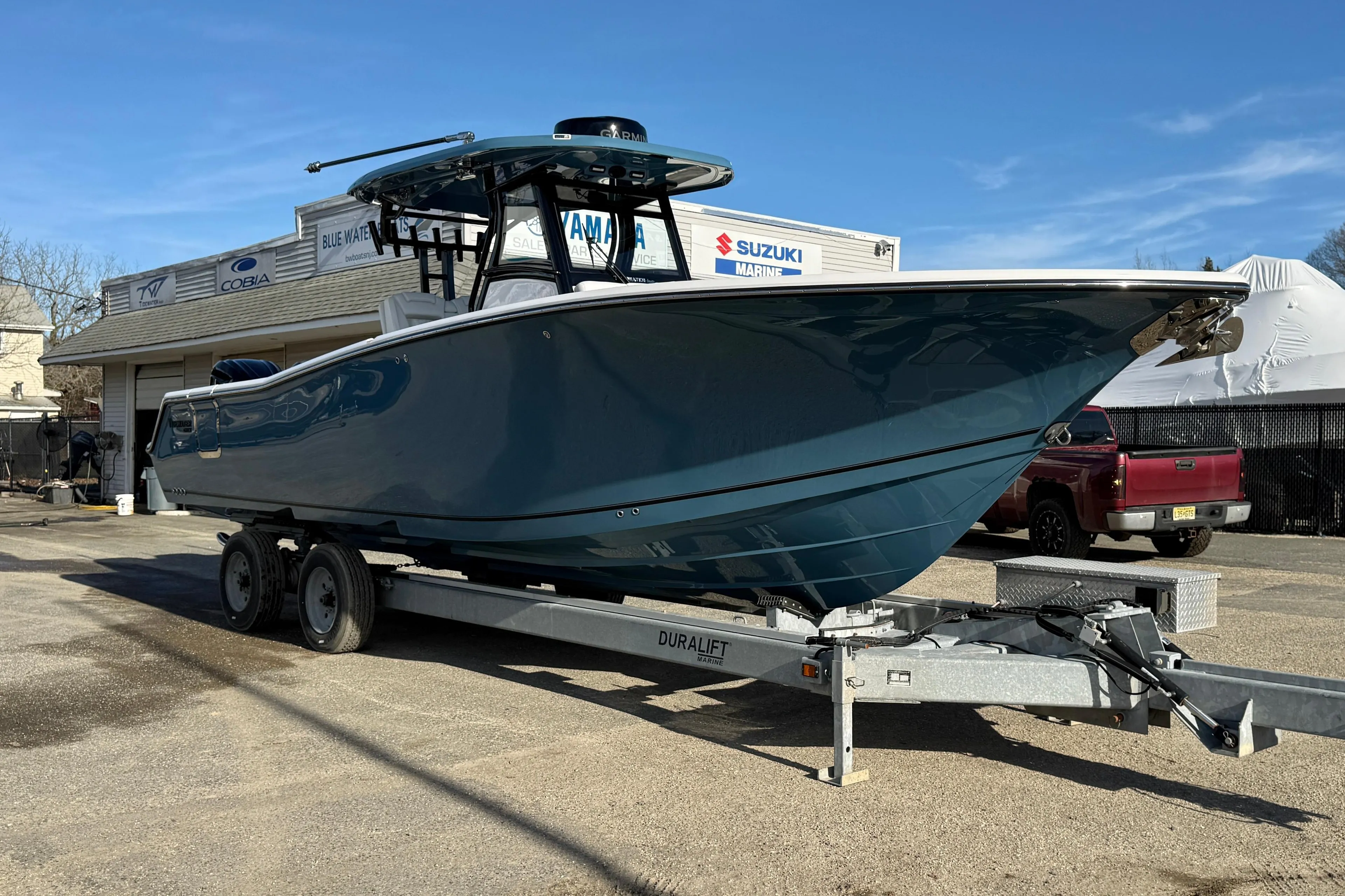 2026 Tidewater 302 CC Adventure boat on trailer at dealership.