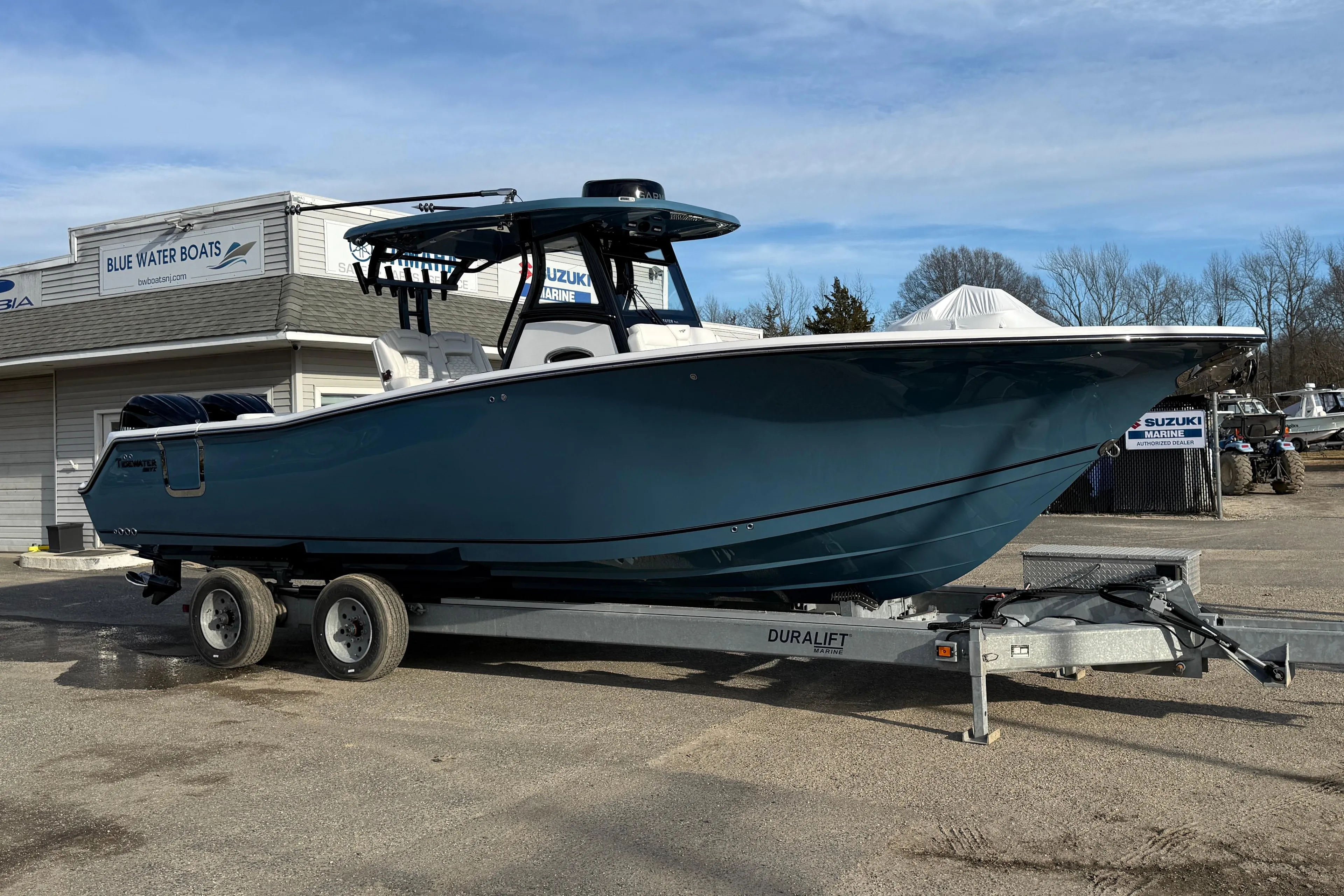 2026 Tidewater 302 CC Adventure boat on trailer at Blue Water Boats dealership.