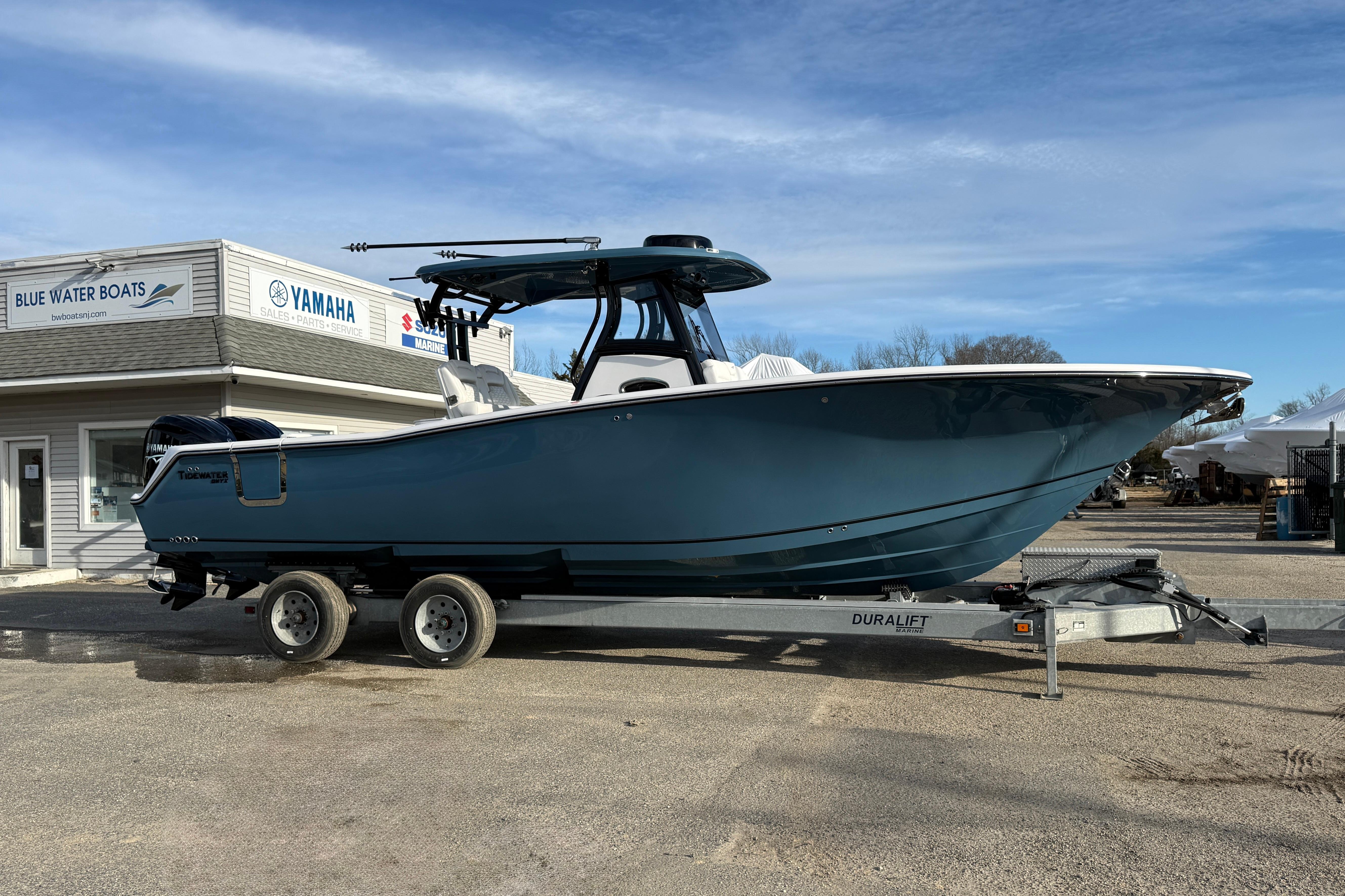 2026 Tidewater 302 CC Adventure boat on trailer at Blue Water Boats dealership.