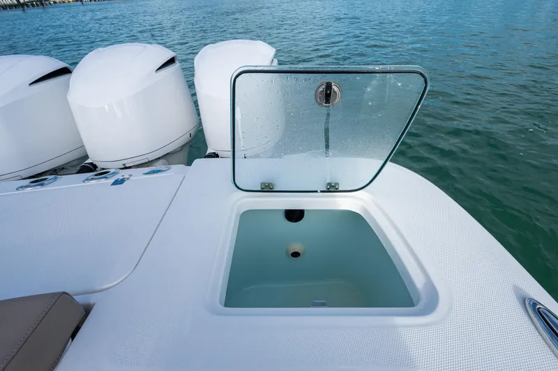  Yacht Photos Pics 2020 Edgewater 370CC boat with open storage compartment and triple outboard motors on water.