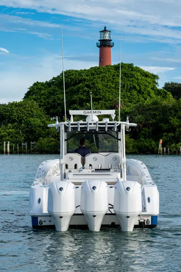  Yacht Photos Pics 2020 Edgewater 370CC boat on water with lighthouse in background.