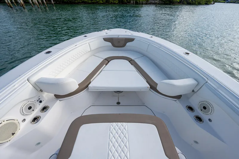  Yacht Photos Pics 2020 Edgewater 370CC boat interior with cushioned seating and table on calm water.