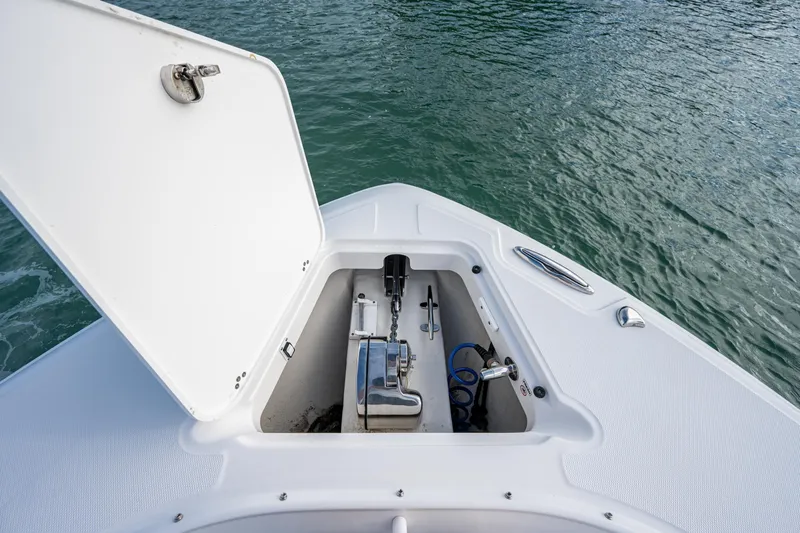  Yacht Photos Pics Edgewater 370CC 2020 boat anchor compartment open on calm water.