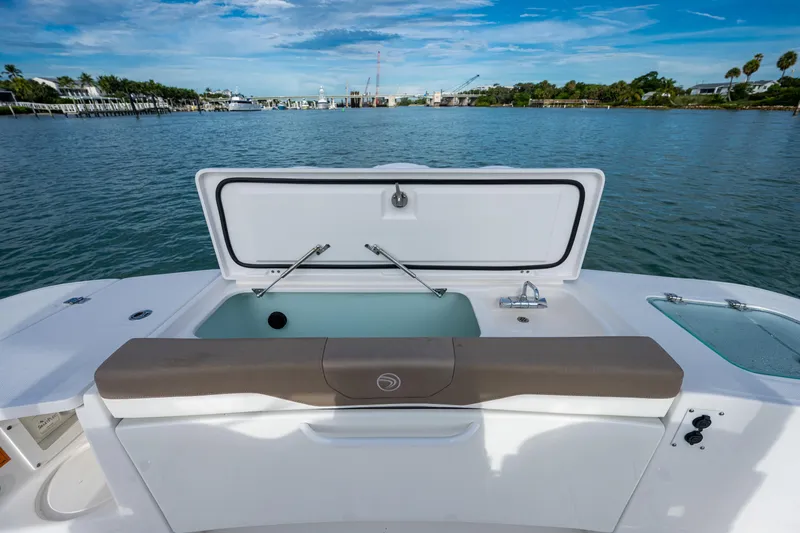  Yacht Photos Pics Edgewater 370CC 2020 boat with open storage compartment on calm water.