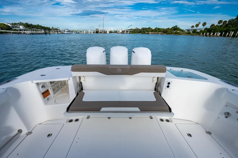  Yacht Photos Pics Edgewater 370CC 2020 boat with spacious deck and seating, overlooking serene water and blue sky.