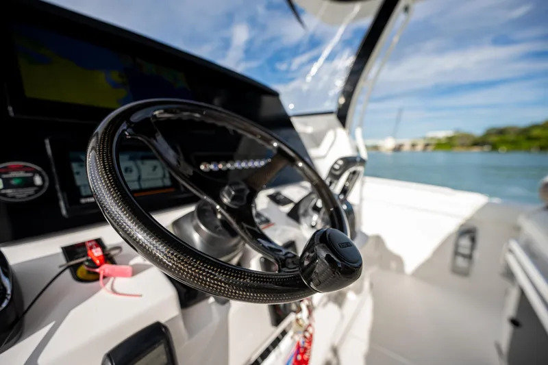  Yacht Photos Pics Steering wheel of 2020 Edgewater 370CC boat with modern dashboard controls.
