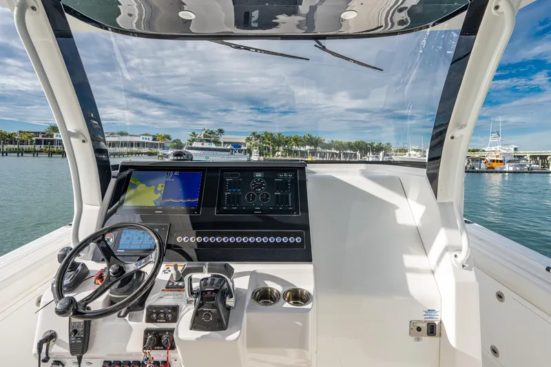  Yacht Photos Pics 2020 Edgewater 370CC boat helm with modern navigation system and scenic marina view.