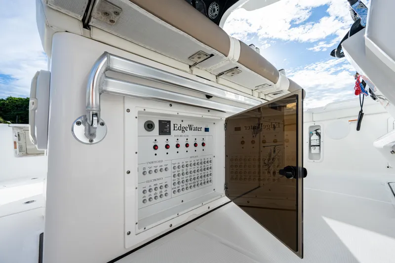  Yacht Photos Pics 2020 Edgewater 370CC boat control panel with open compartment, showcasing switches and wiring.
