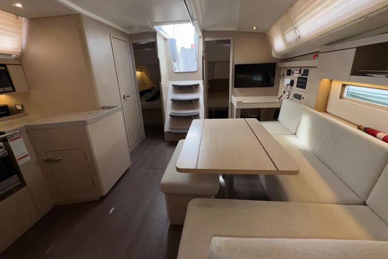 Bluebird Yacht Photos Pics Modern interior of 2022 Beneteau Oceanis 40.1 yacht with dining area and kitchen.