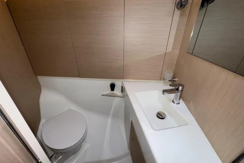 Bluebird Yacht Photos Pics Modern bathroom in 2022 Beneteau Oceanis 40.1 yacht, featuring sleek sink and toilet.