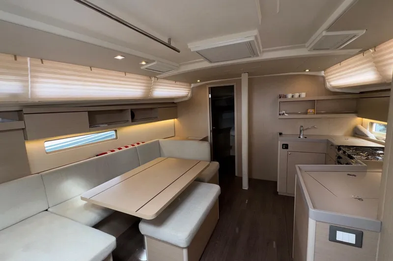 Bluebird Yacht Photos Pics Luxurious interior of 2022 Beneteau Oceanis 40.1 yacht with modern kitchen and seating area.