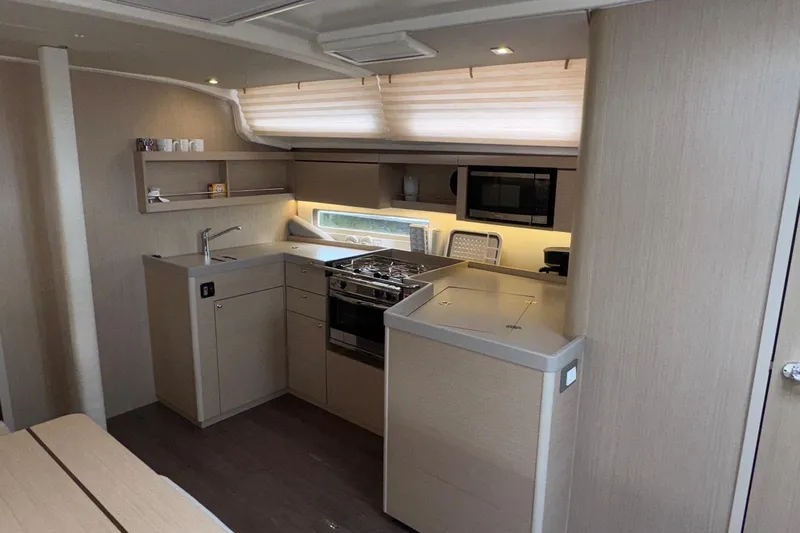 Bluebird Yacht Photos Pics Modern kitchen interior of 2022 Beneteau Oceanis 40.1 yacht with sleek cabinetry and appliances.