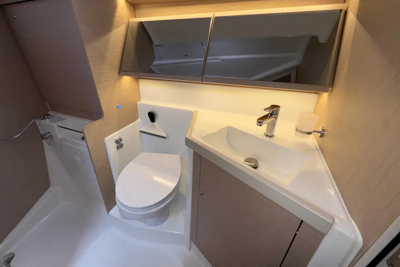 Bluebird Yacht Photos Pics Modern bathroom in 2022 Beneteau Oceanis 40.1 yacht, featuring sleek sink and toilet.