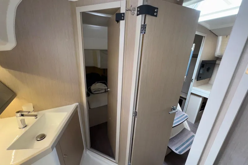 Bluebird Yacht Photos Pics Interior of 2022 Beneteau Oceanis 40.1 yacht, featuring a compact bathroom and cabin entrance.