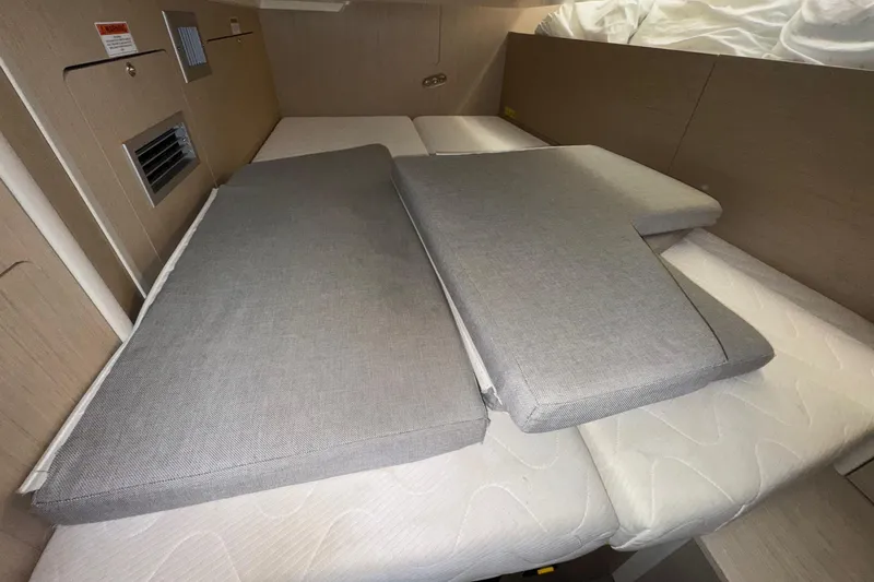 Bluebird Yacht Photos Pics Interior cabin of 2022 Beneteau Oceanis 40.1 yacht with cushions on bed.