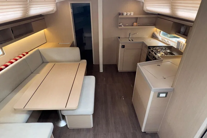 Bluebird Yacht Photos Pics Modern interior of 2022 Beneteau Oceanis 40.1 yacht with kitchen and dining area.