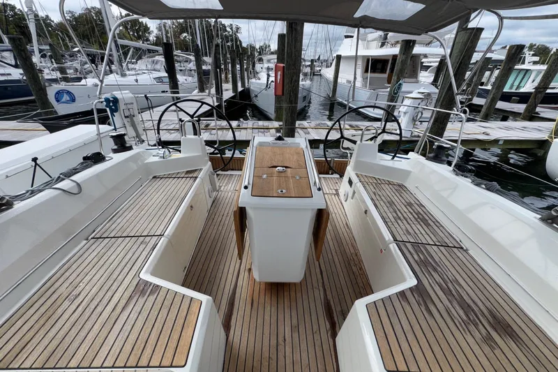 Bluebird Yacht Photos Pics 2022 Beneteau Oceanis 40.1 yacht cockpit with dual steering wheels and wooden deck.