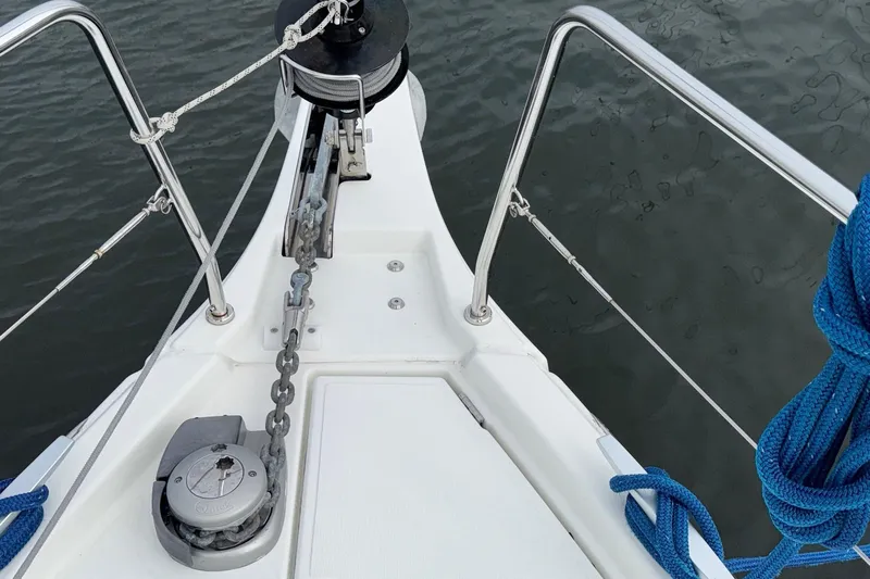 Bluebird Yacht Photos Pics Bow of 2022 Beneteau Oceanis 40.1 sailboat with anchor chain and blue rope.