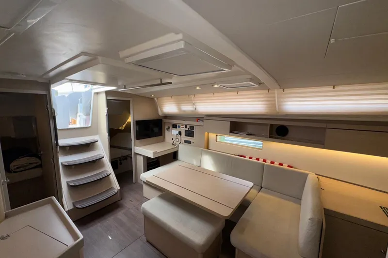 Bluebird Yacht Photos Pics Modern interior of 2022 Beneteau Oceanis 40.1 yacht, featuring cozy seating and sleek design.