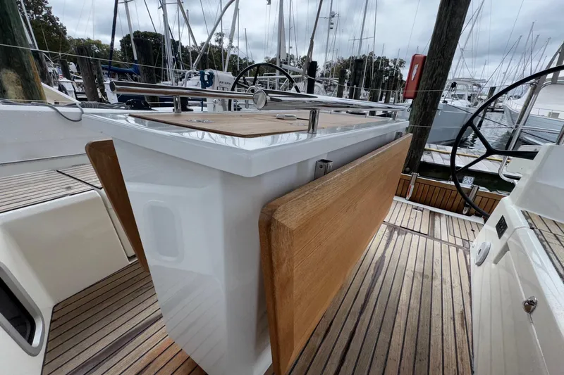 Bluebird Yacht Photos Pics 2022 Beneteau Oceanis 40.1 yacht cockpit with wooden table and steering wheel.