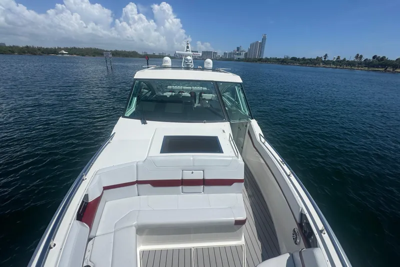  Yacht Photos Pics 2020 Formula 430 Super Sport Crossover yacht on calm water, city skyline in background.