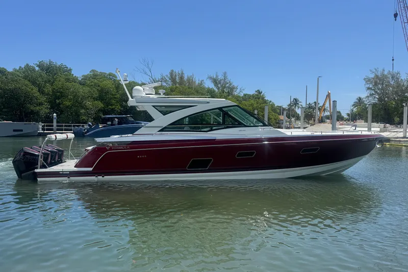  Yacht Photos Pics 2020 Formula 430 Super Sport Crossover boat docked in a serene marina setting.