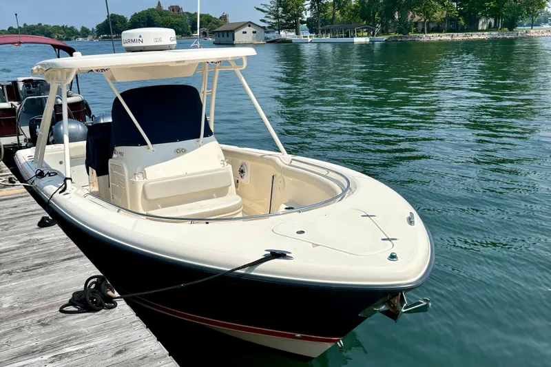 Siriusly Yacht Photos Pics 2012 Pursuit S 280 Sport boat docked on calm water.