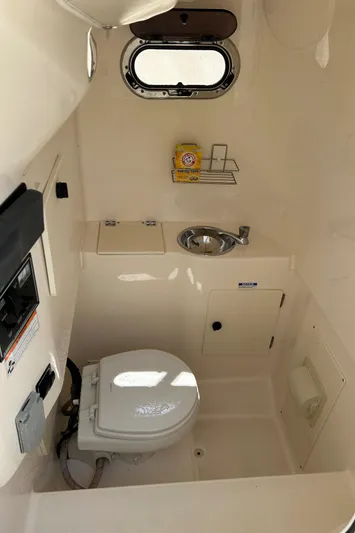 Siriusly Yacht Photos Pics 2012 Pursuit S 280 Sport boat bathroom with toilet, sink, and window.