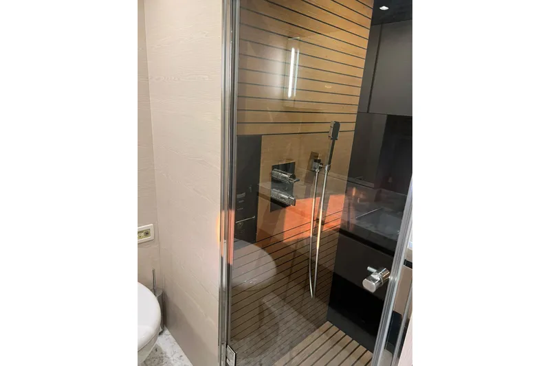 Yacht Photos Pics Luxurious shower area in 2015 Azimut 80 yacht with modern fixtures and wooden accents.