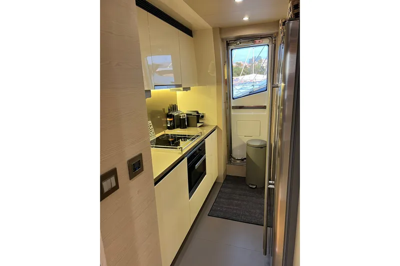  Yacht Photos Pics Modern kitchen interior on 2015 Azimut 80 yacht, featuring sleek cabinetry and appliances.